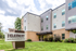 Modern apartment building entrance with lush landscaping and a prominent sign reading 'The Element' located at 234.