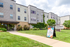 Charming apartment exterior with lush landscaping and a welcoming entrance, featuring spacious 3 and 4-bedroom units available for lease.