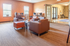 Inviting lounge area with cozy brown leather seating, ambient string lights, and a charming cafe bar setup.