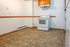 Cozy kitchen with a modern white stove, stylish cabinetry, and ample floor space, perfect for culinary creativity.