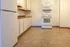 Bright and welcoming kitchen with modern appliances, ample cabinetry, and durable flooring.
