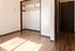 Sunlit room with elegant hardwood floors and spacious closet, offering a bright and inviting space for personalization.