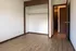 Bright, spacious room with elegant wood flooring and a built-in closet, perfect for stylish living.