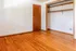 Charming and bright room with polished hardwood floors and open closet space.