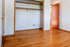 Inviting bedroom with stylish hardwood flooring and a spacious built-in closet, perfect for creating your dream living space.