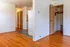 Inviting apartment interior with warm hardwood floors, open layout, and ample closet space.