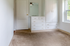 Bright room featuring built-in white storage cabinets and a sunny window, ideal for cozy living.