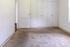 Inviting bedroom with plush carpet, ample built-in storage, and bright natural light.