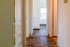 Inviting hallway with polished wood floors, natural light, and sleek built-in storage.