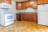 Charming kitchen with warm wooden cabinets, sleek countertops, and modern appliances, perfect for culinary adventures.