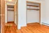 Charming bedroom with beautiful hardwood floors and spacious double closets, offering ample storage space.