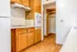 Charming kitchen with wooden cabinets, tiled backsplash, and warm hardwood floors, exuding a cozy and inviting atmosphere.