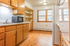 Bright and inviting kitchen with wooden cabinets, ample counter space, and natural light from large windows.