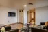 Inviting modern living room with cozy seating, stylish decor, and a sleek wall-mounted TV, perfect for relaxation.