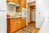 Cozy kitchen with warm wood cabinetry, modern appliances, and a charming walk-in pantry.