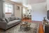 Charming living space with elegant gray sofa, stylish coffee table, and cozy dining area, perfect for relaxation and entertaining.