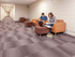 Inviting hallway with modern lounge featuring brown seating, perfect for collaborative work or relaxation.