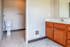Modern bathroom featuring sleek vanity, spacious mirror, and elegant fixtures in a bright, inviting space.