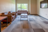 Modern living room with cozy brown sofas, a sleek coffee table, and a large window providing natural light, ideal for relaxation.