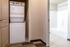 Modern apartment with in-unit stacked washer and dryer adjacent to a sleek, bright bathroom.