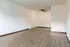 Bright, open living space with elegant wooden flooring and modern ceiling fan, perfect for seamless interior design.