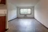 Bright living room with large window and wood flooring, offering a cozy and inviting atmosphere.