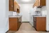 Cozy kitchen with vintage wooden cabinets, modern appliances, and elegant countertops.