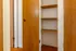Cozy apartment shelving unit with wooden doors and ample storage space.