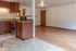 Inviting open-concept kitchen with warm wood cabinetry and hardwood floors, perfect for entertaining.