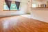 Bright open living space with large window, hardwood floors, and a cozy breakfast bar.