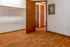 Inviting empty room with warm wooden floors and open closet, perfect for personalization.