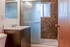Modern bathroom design with sleek sink, glass-enclosed shower, and textured tiles for a luxurious feel.