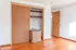 Bright room with hardwood flooring, spacious walk-in closet, and wooden doors, perfect for a modern home.