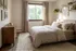 Bright and cozy bedroom with large window, elegant wooden dresser, and stylish decor.