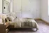 Inviting master bedroom with elegant wooden furniture, plush bedding, soft lighting, and modern decor.