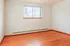 Bright, airy room with warm wooden floors and a large window inviting natural light.