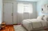 Bright and cozy bedroom featuring soft natural light, inviting neutral tones, and elegant decor.