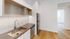 Kitchen with stainless steel dishwasher, refridgerator and white cabinets