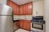 Kitchen with stainless steel appliances at Park East Apartments in Adams Morgan