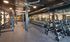 another view of workout room with free weights, machines and barbells