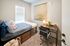 bedroom with bed, dresser and desk