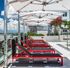 Black & red lounge chairs shaded on sun deck by rooftop pool  at The Henry | Apartments in Tampa, FL