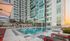 Pool wiht black and red lounging chairs  at The Henry | Apartments in Tampa, FL