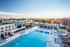 Rooftop pool at dusk with sundeck seating  at The Henry | Apartments in Tampa, FL