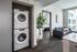 Washer and dryer in nook off the living-dining area in an apartment  at The Henry | Apartments in Tampa, FL