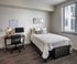 Bedroom with carpet, bed and desk  at The Henry | Apartments in Tampa, FL