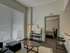Living area with large windows opening into bedroom at The Henry | Apartments in Tampa, FL.