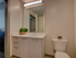 White vanity with large mirror in bathroom at The Henry | Apartments in Tampa, FL.