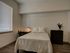 Bedroom with large window, desk, and plank-style flooring at The Henry | Apartments in Tampa, FL.