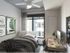 Bedroom with furnishings, ceiling fan, and window view